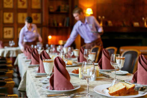 Waiters prepping a large table setting