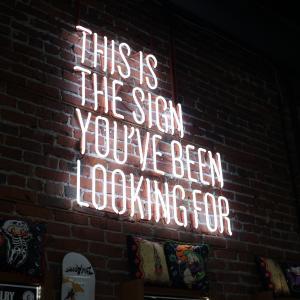 a neon sign that reads 'this is the sign you've been looking for'