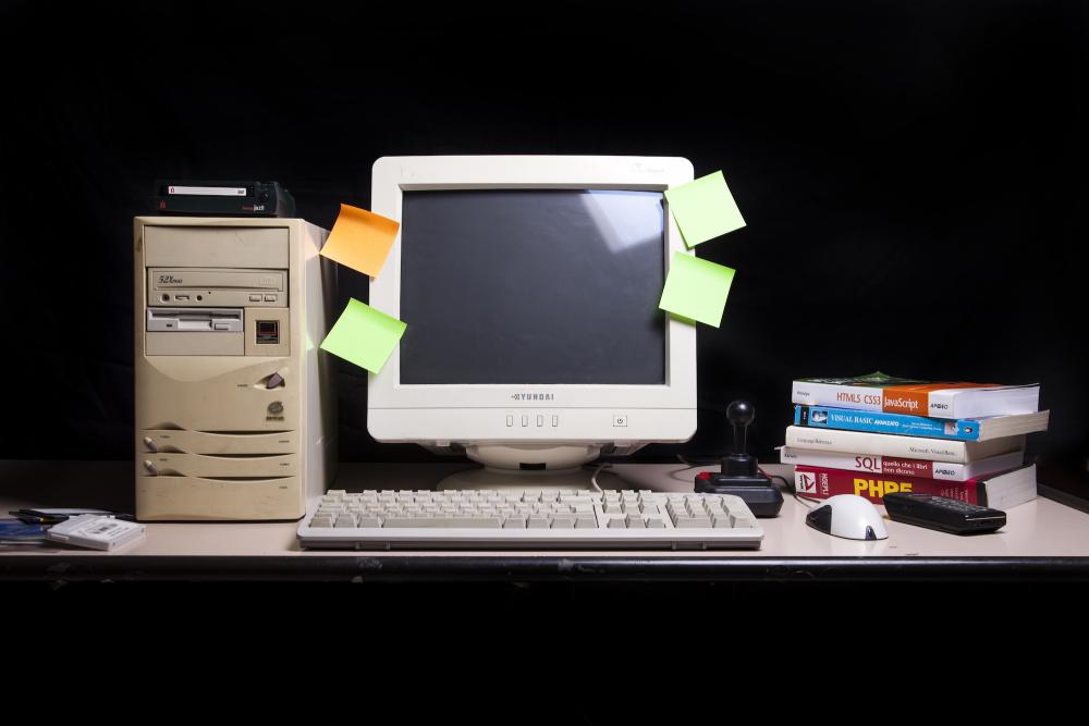 an old computer turned off with sticky notes of various colors attached to the screen