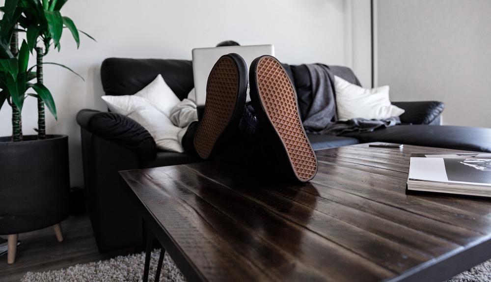 person using a laptop sitting on a couch