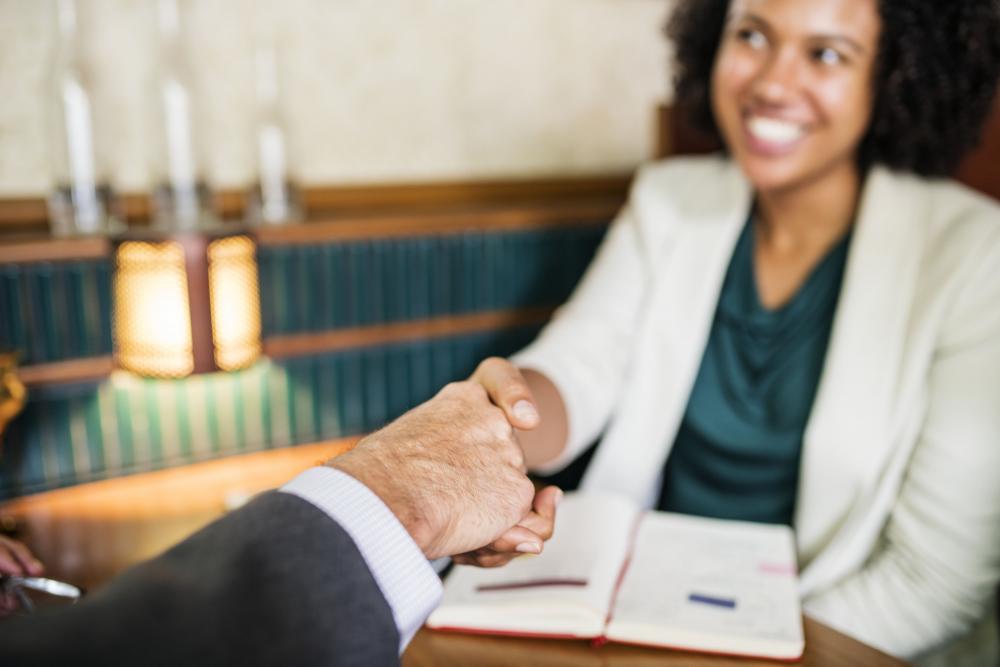 woman shaking hands with a business man