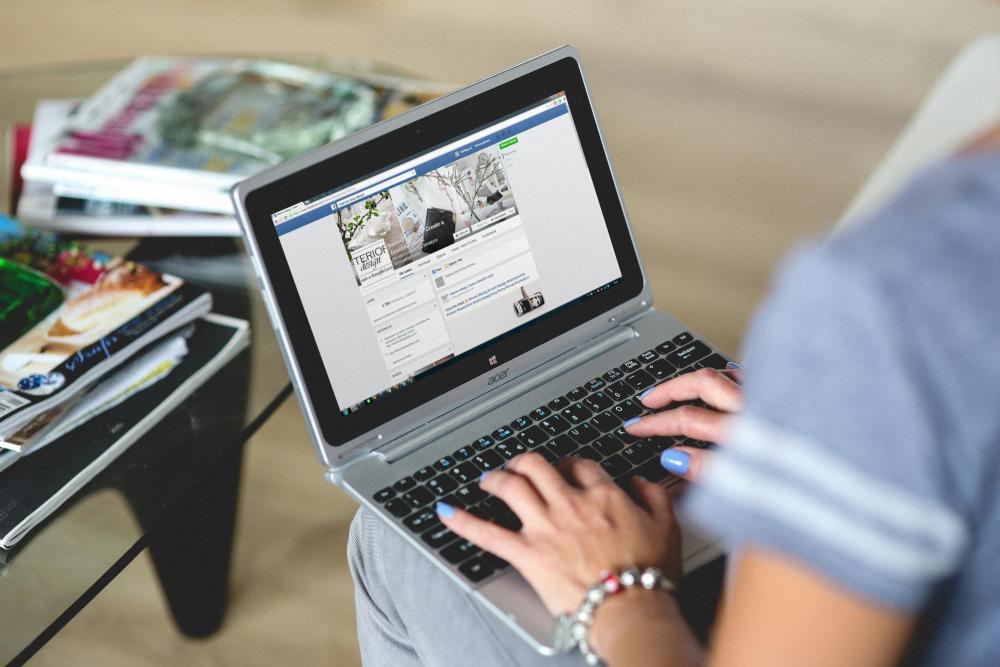 a person typing on a laptop in their lap